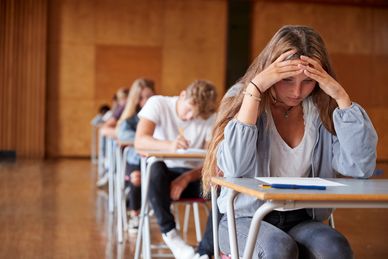Students sitting in an exam hall during an exam