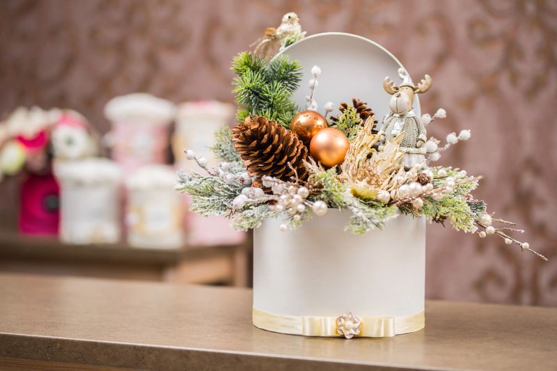 Luxury Christmas gift box in flower shop with seasonal decoration.