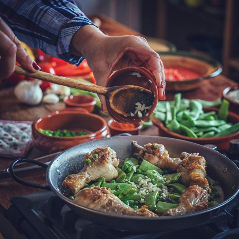Preparing Chicken Paella with Green Beans, Peas and Paprika