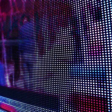 Close-up of a vibrant digital LED screen with colorful pixel patterns.