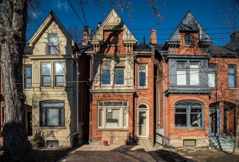 Exterior of old victorian style house under renovation. Sunny winter day on urban city street.