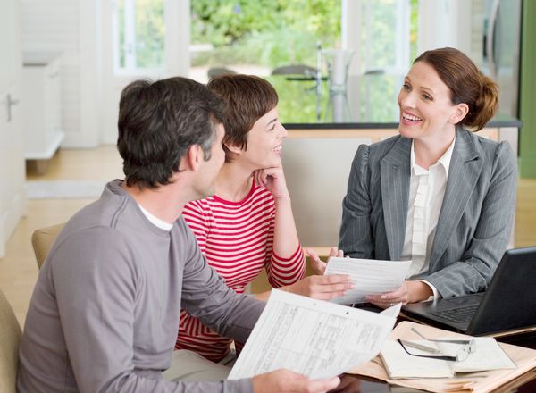 Couple discussing documents with a professional.