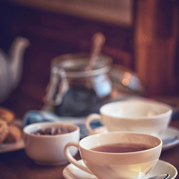 Cozy coffee mug in vintage tearoom setting.