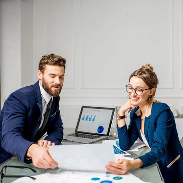 Two coworkers reviewing charts in an office.
