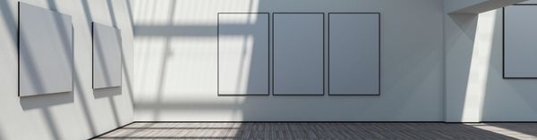Empty gallery room with blank canvases and sunlight shadows.