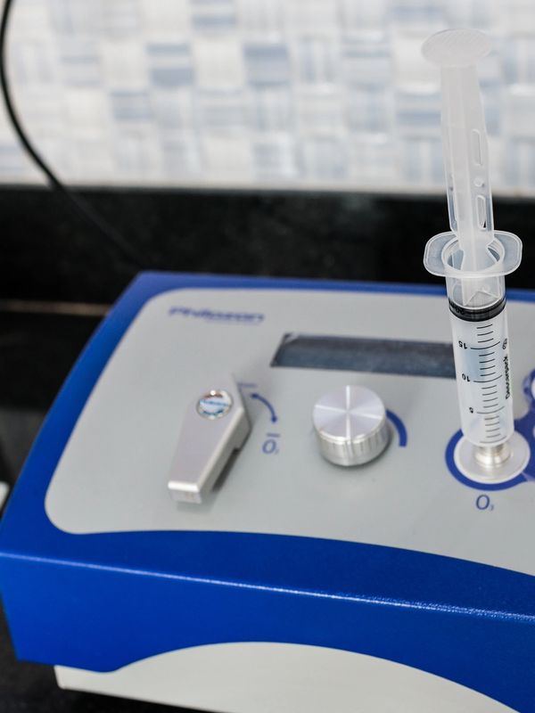 Close-up of a medical device with a syringe attached.