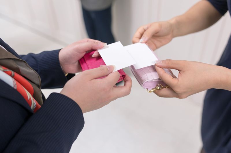 Business women exchanging business cards