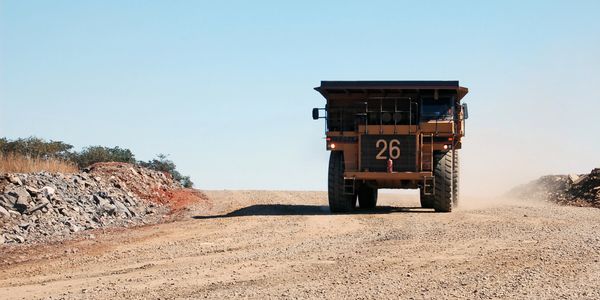 Large mining dump truck on dirt road.