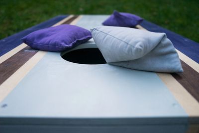 Bags on a cornhole board ready for a game outdoors.