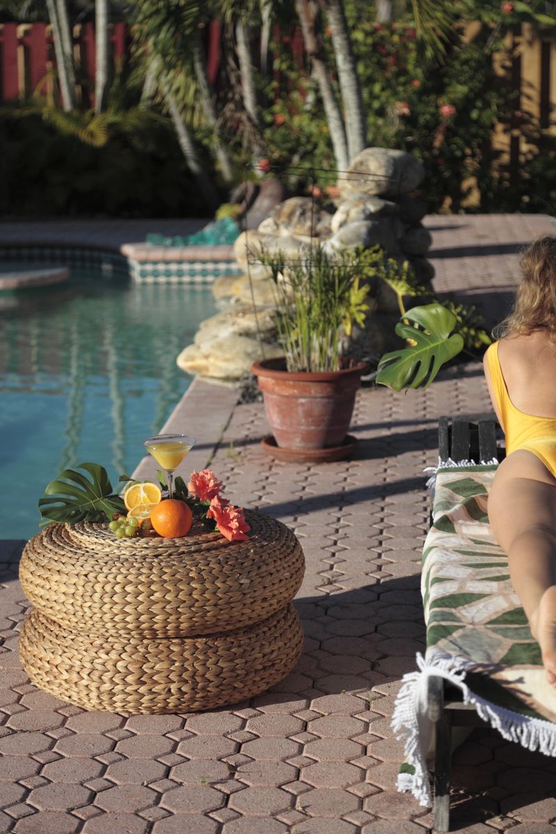 Woman sunbathing by the pool.