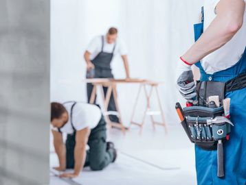 A group of men working on some furniture.