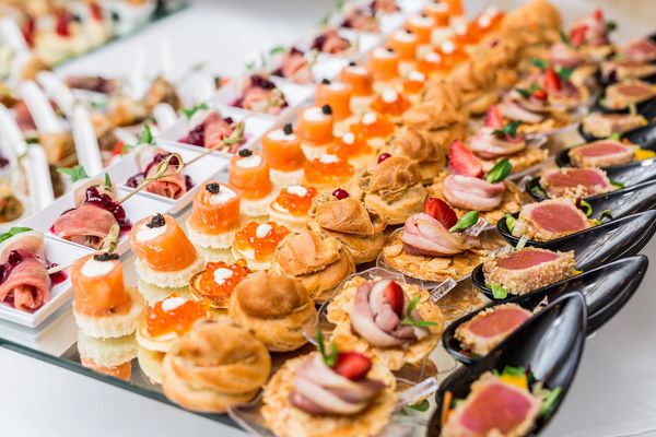 Platter of gourmet canapes with profiteroles, seared tuna and roast beef crostini