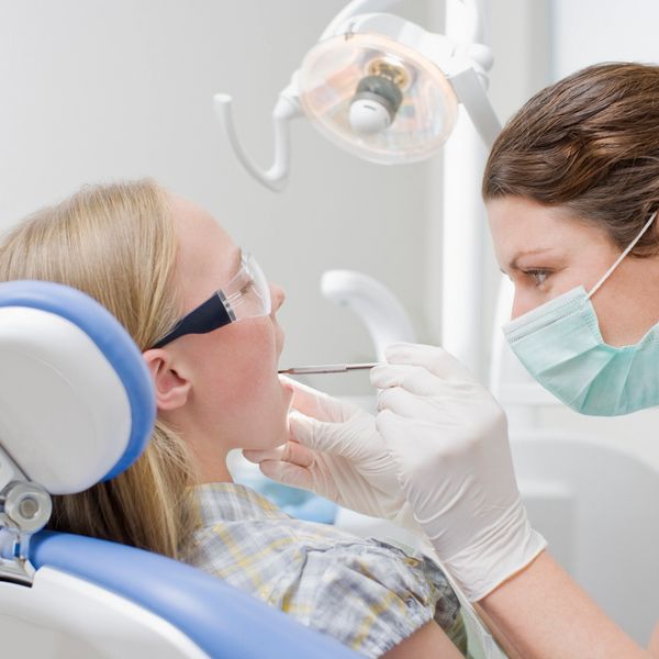 A professional dentist performs advanced cosmetic dentistry on a patient.