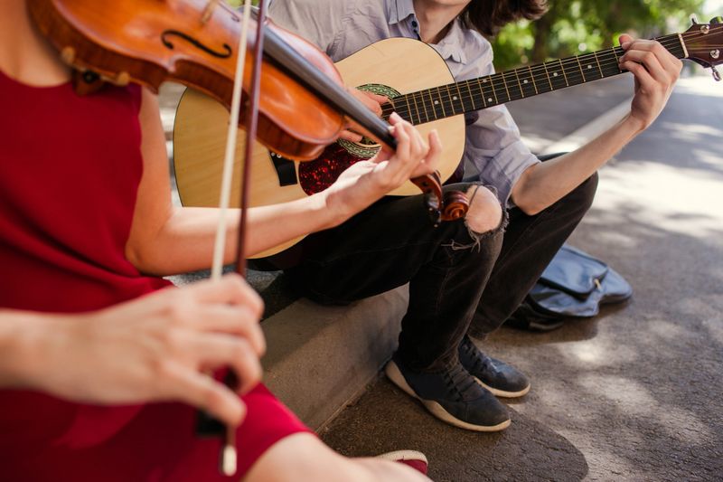 street music duo group performing in a park. free spirits hippie romance concept