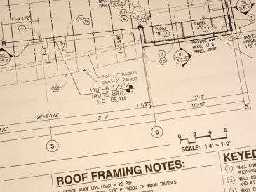 Close-up of architectural blueprint showing roof framing notes.