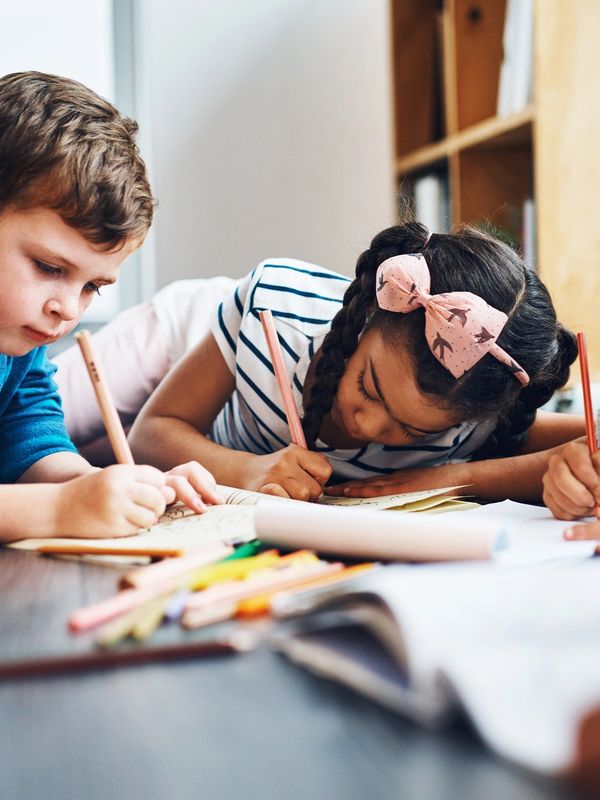 "Three young children working together on a colouring and drawing activity in a classroom setting. The image highlights creativity, focus, learning, collaboration, and emotional wellbeing through art-based activities. Ideal for educational content, wellbeing resources, therapeutic colouring programmes, and school-based creative learning initiatives."
