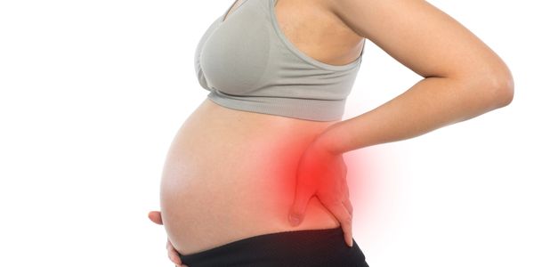Person with pregnant belly indicating suffering from low back pain