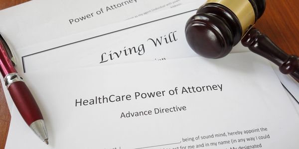 Legal documents including Healthcare Power of Attorney and Living Will with a judge's gavel.