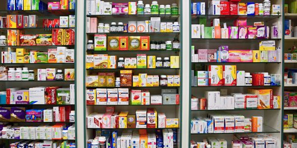 Pharmacy shelves filled with various medicines and supplements.