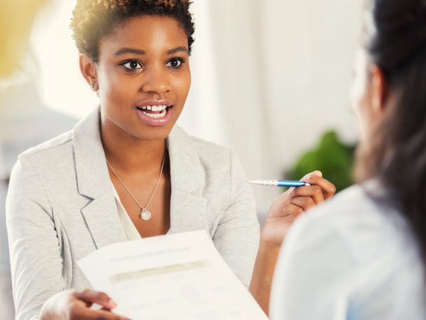 Professional woman explaining a document during a meeting.
