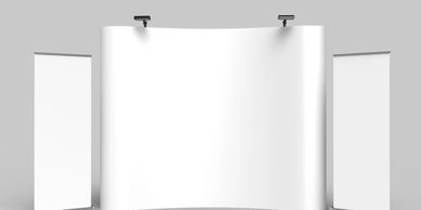 Blank white exhibition banners and backdrop stands on gray floor.