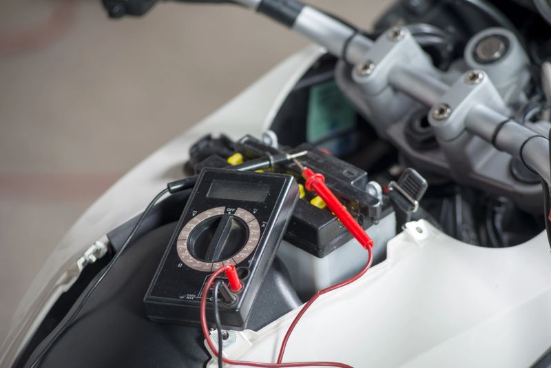 a testing the battery of the motorcycle
