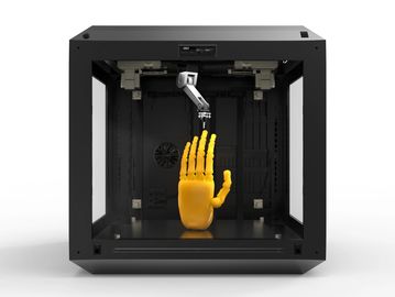 3D printer creating a yellow robotic hand model.