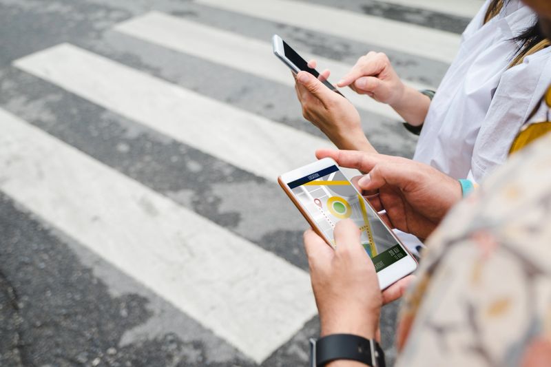Traveler use map on mobile phone app to search for route location of place with gps on street when travel in city,Technology in lifestyle