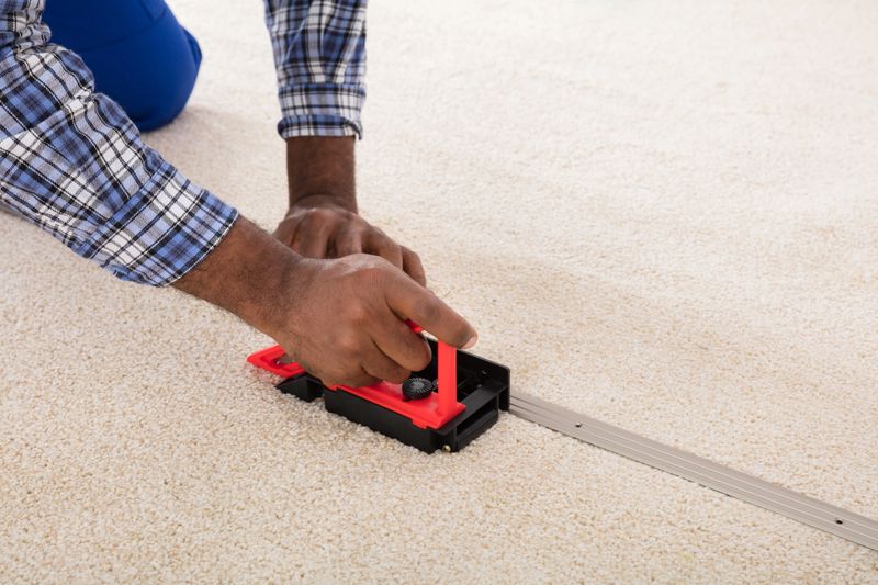 Craftsman Installing Carpet On Floor Using Fitter