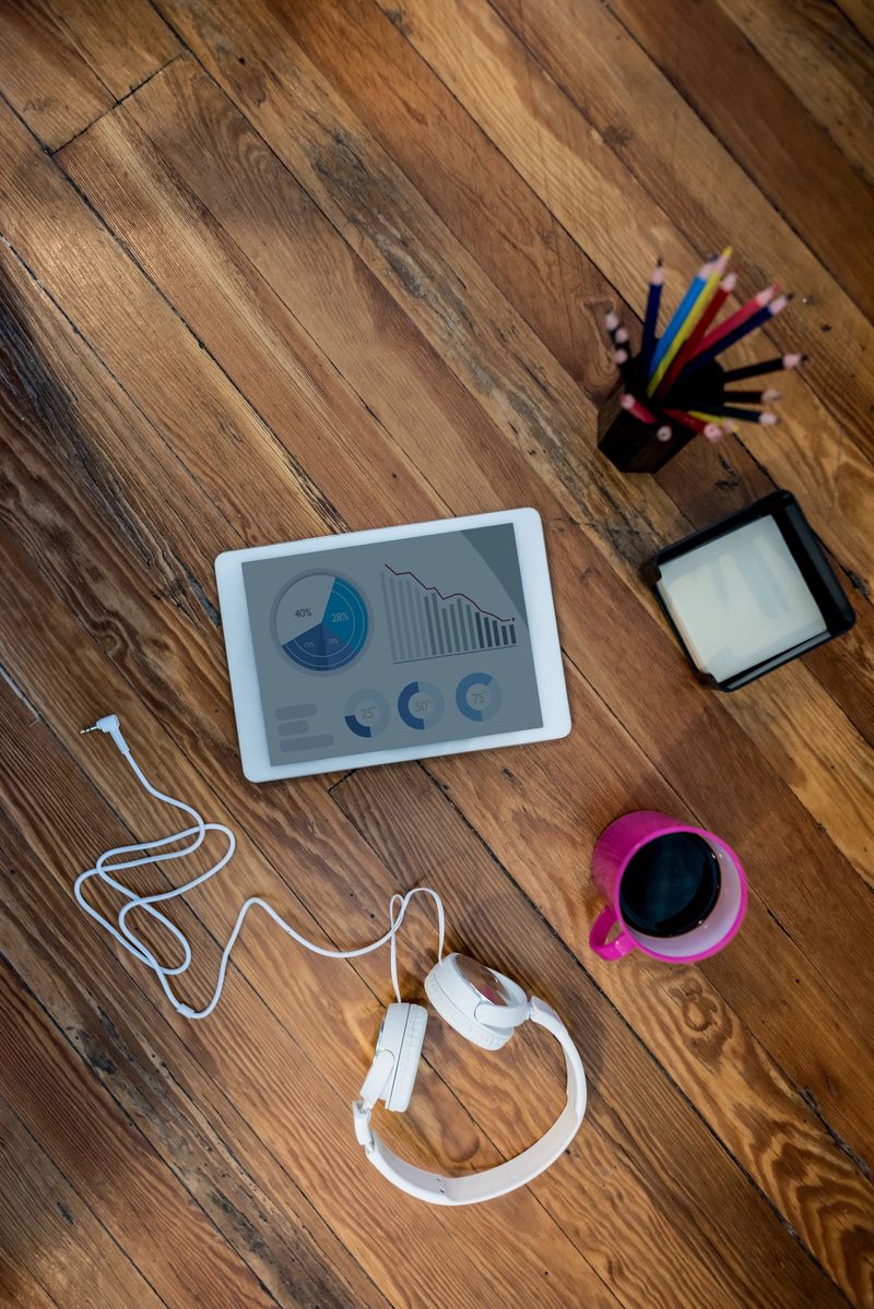 Close-up at a creative office with a tablet computer and headphones on the desk. **DESIGN ON SCREEN WAS MADE FROM SCRATCH BY US**