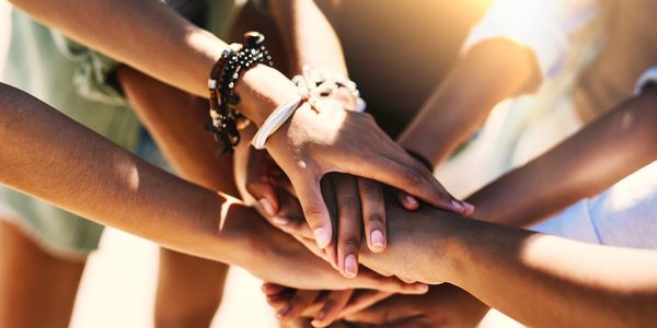 Group of hands coming together in connection