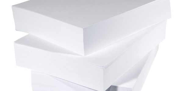 Stack of three white paper reams.