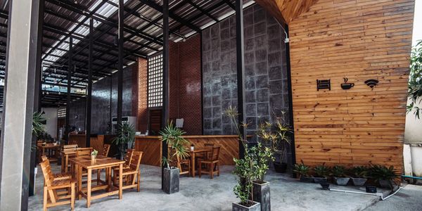 Modern cafe with wooden furniture and industrial decor.