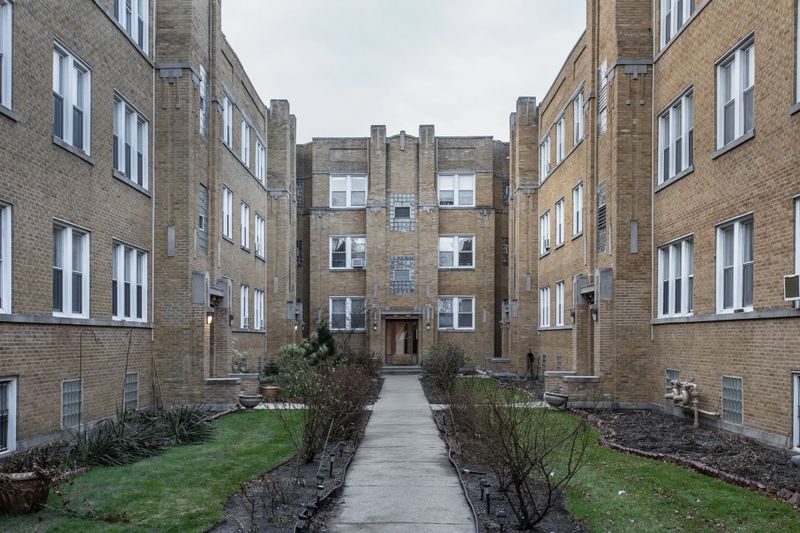 Yellow brick courtyard with grass and leading sidewalk