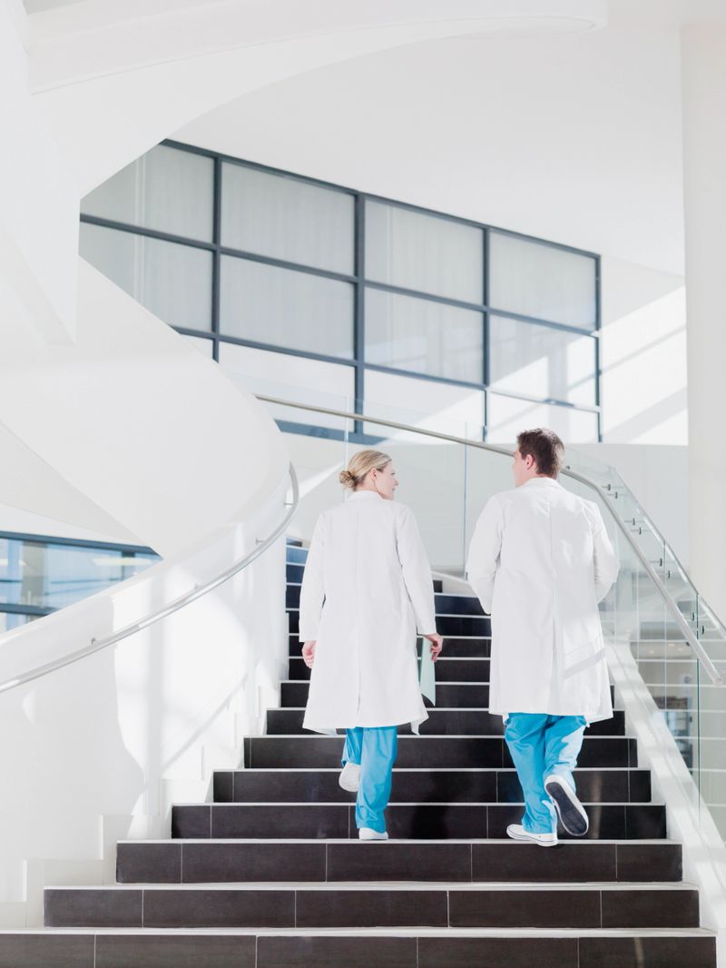 Doctors walking up staircase in hospital