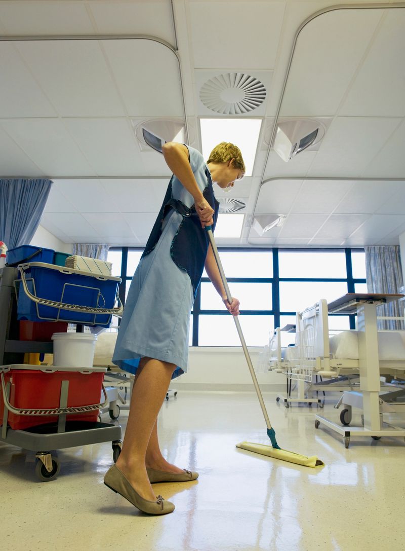 Janitor cleaning hospital room