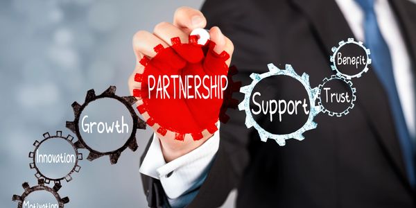 Businessman highlighting partnership and related concepts with gear icons.