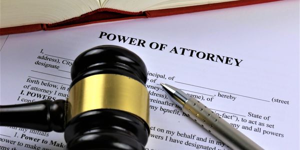 Power of Attorney document with gavel and pen.