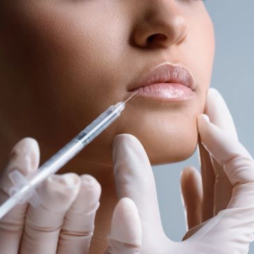 Close-up of lip injection procedure.