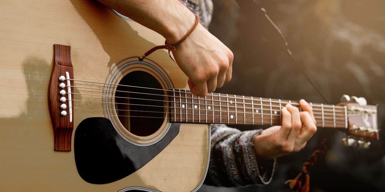 An acoustic guitar being played