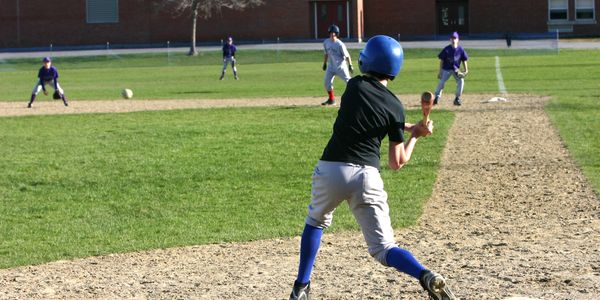 Young baseball player batting during a game.