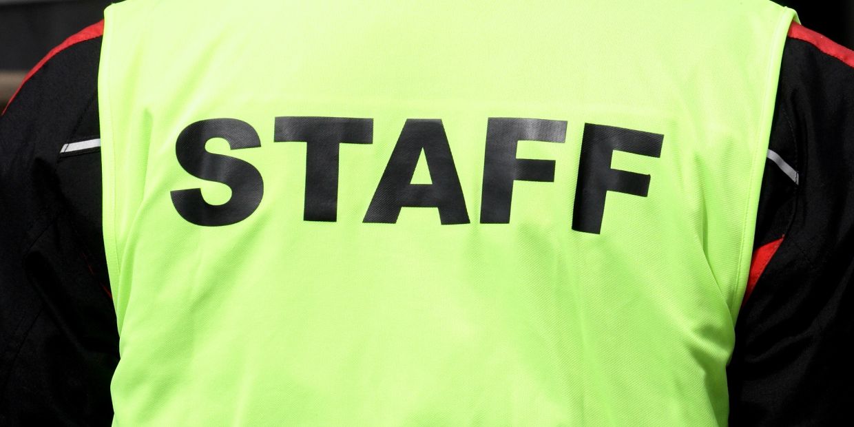High-visibility vest with STAFF printed on the back.
