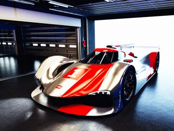 Race car with number 1 in a dimly lit garage.