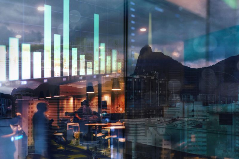 double exposure of data graphs and people in office in city
