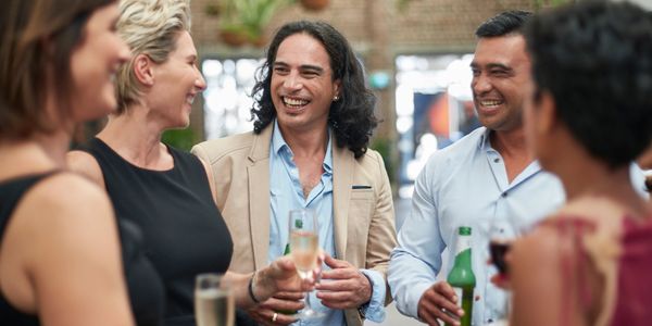 A group of friends enjoying drinks and laughter at a social gathering.