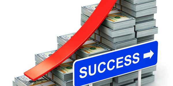 Stacks of money with an upward arrow showing growth and a success sign.