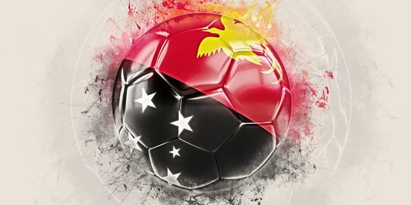 Soccer ball with Papua New Guinea flag colors and stars in artistic splash style.
