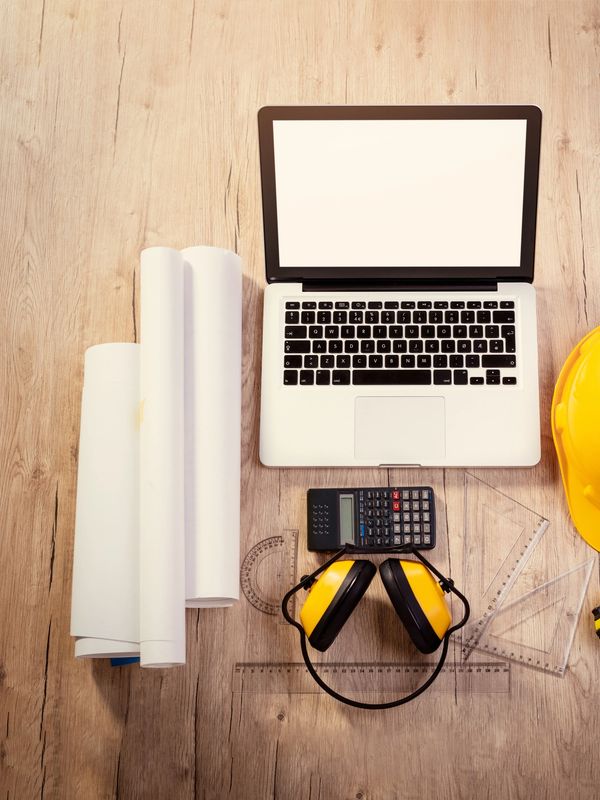 Work essentials for construction or engineering on a wooden table.