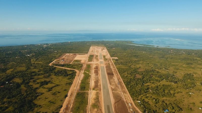 Construction of a new airport terminal on Panglao. Aerial view Modern airport terminal construction site. Construction of a landing strip on the island of Bohol, Philippines. Landing strip. Travel concept.