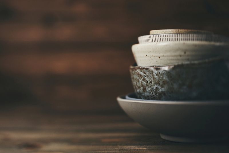 Still life with ceramic bowls on rustic wood table
